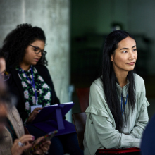 Smiling businesswoman attending conference