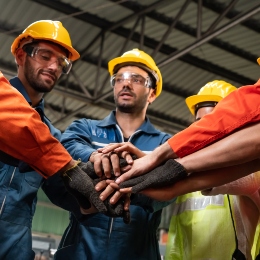 Group of workers putting hands together in a circle